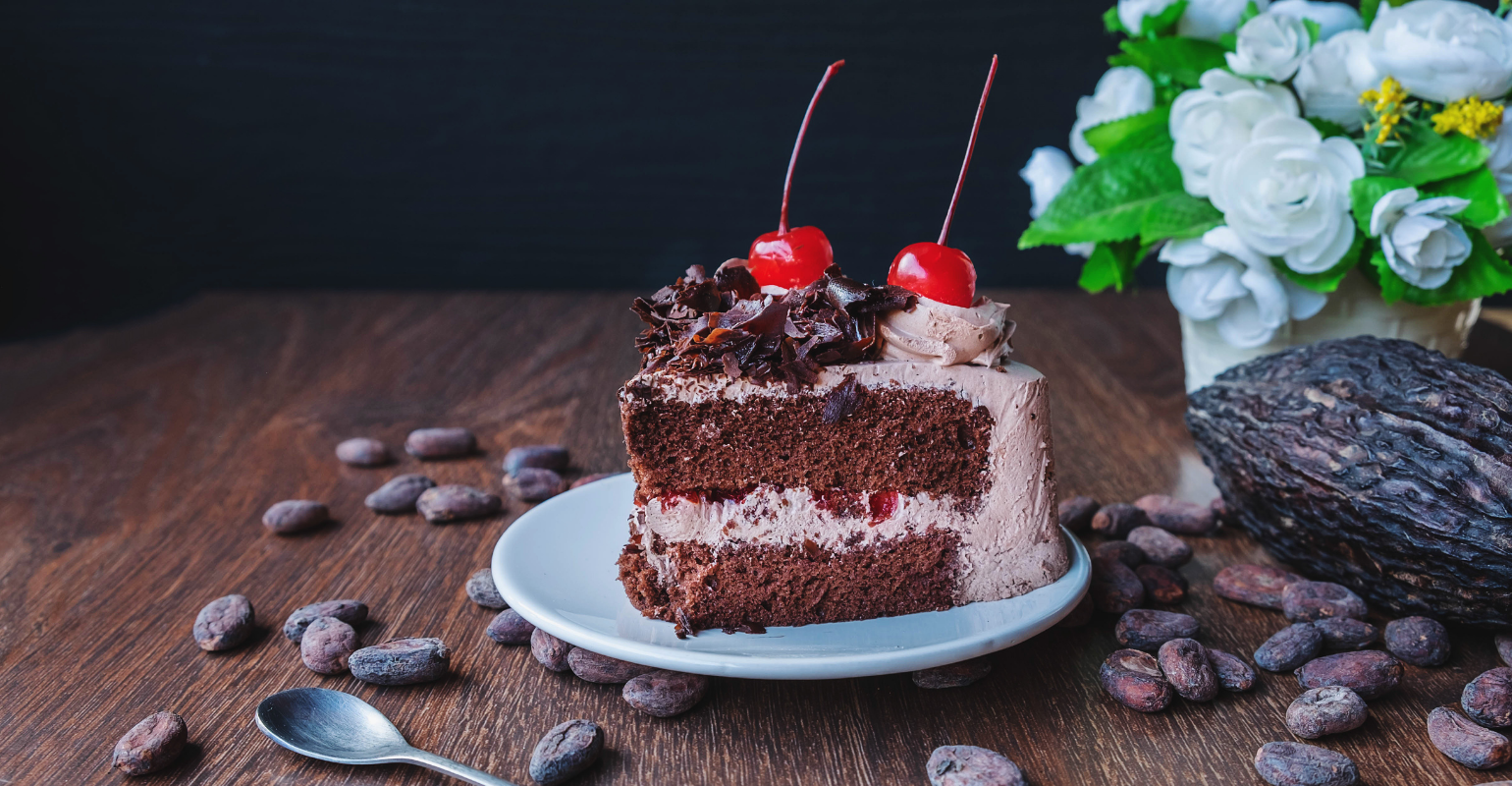 a piece of delicious chocolate cake with cherries on top
