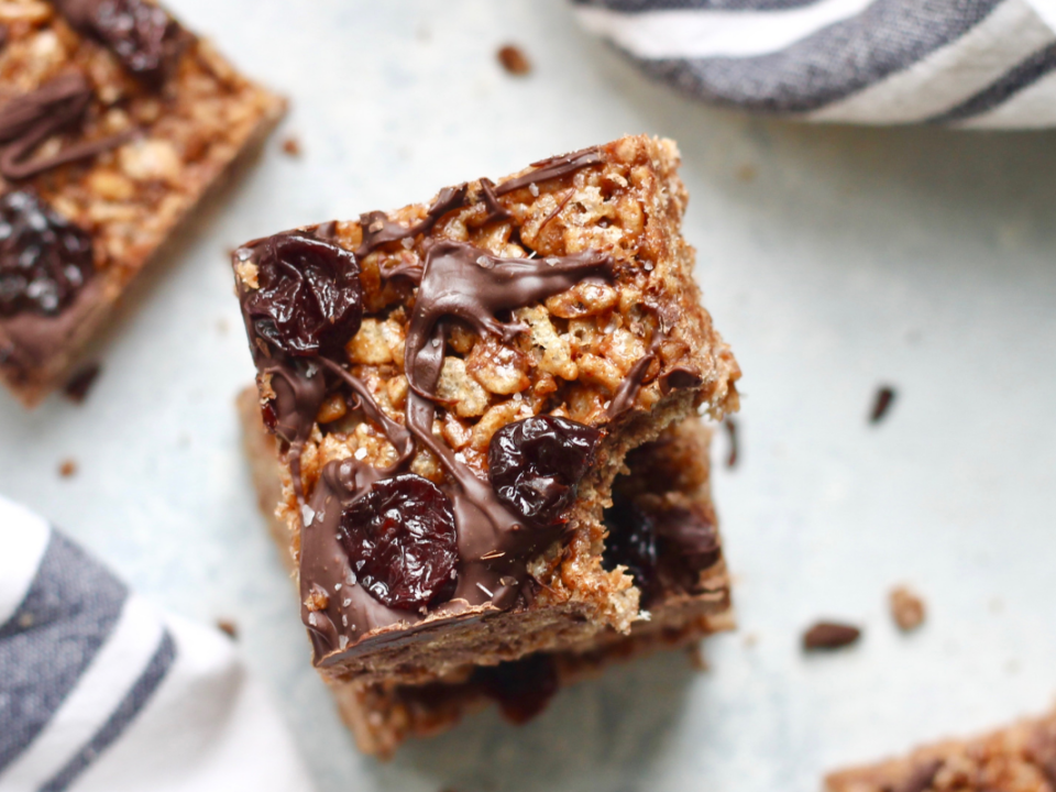 an image of chocolate covered rice crispy treats with dried cherries